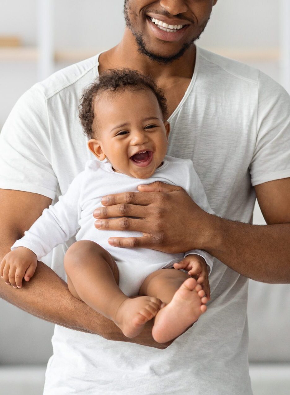 Cropped Shot Of Happy Black Father Holding His Cute Little Laughing Baby Cropped Shot Of Happy Black Father Holding His Cute Little Laughing Baby